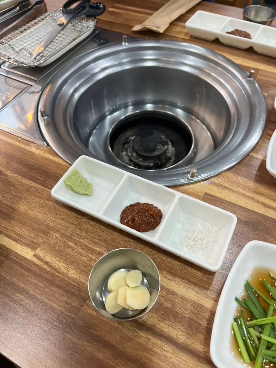 Cabbage salad, seasoned cucumbers, sautéed eggplant, and baek-kimchi side dishes