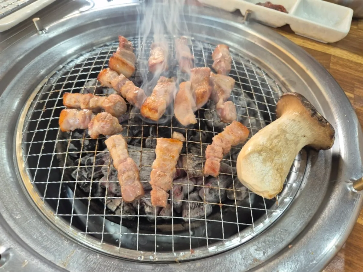 Pork belly and king oyster mushroom grilling together