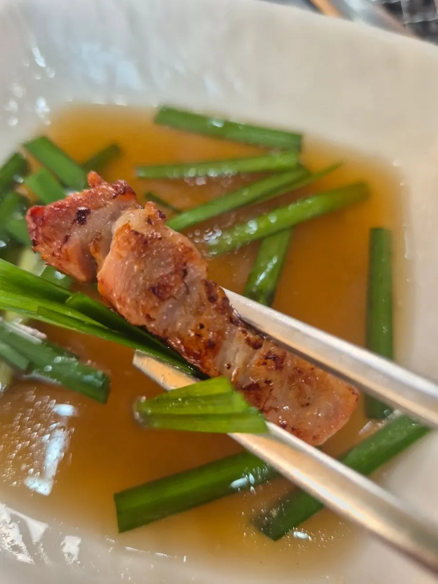 Pork belly wrapped in a lettuce leaf