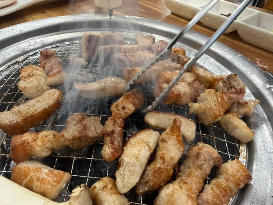 Meat cooking over the charcoal grill