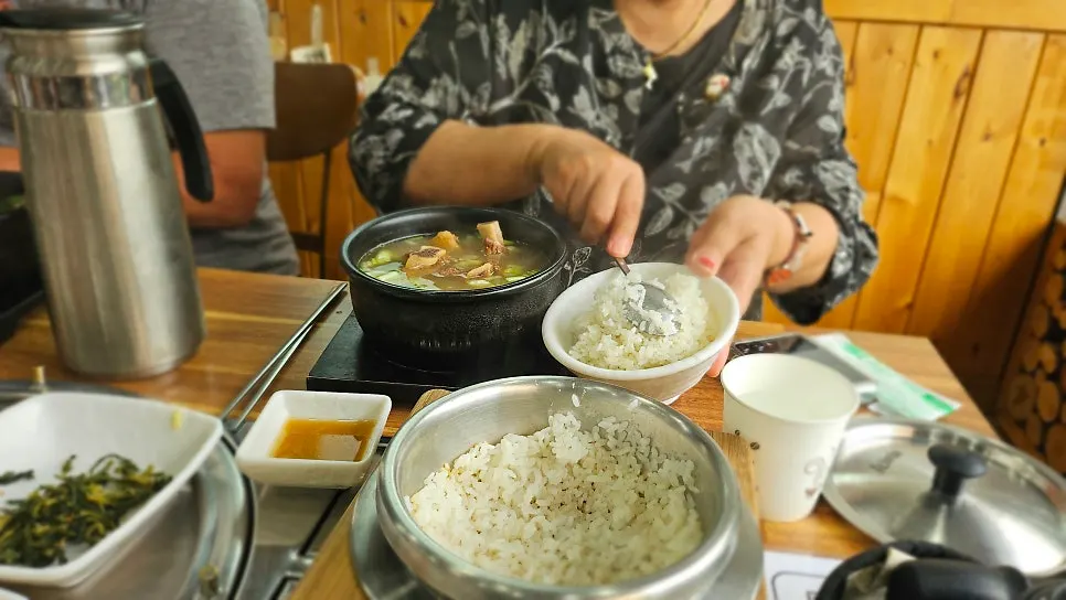 Water poured into the pot after rice is scooped out