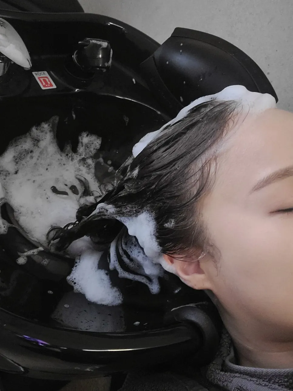 Designer checking the condition of curly hair