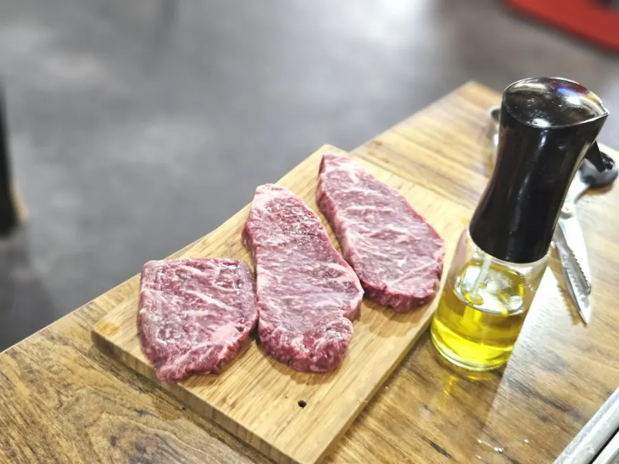 Raw hanwoo sirloin placed on the iron pan
