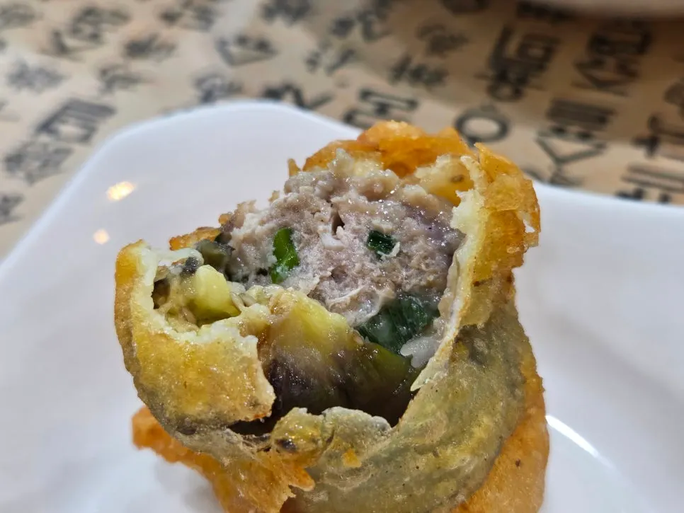 Cross-section of fried eggplant filled with meat and vegetables