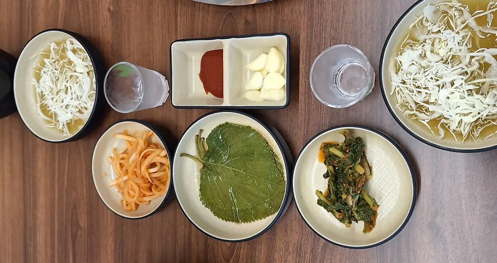 Full spread of basic side dishes served with the dakgalbi