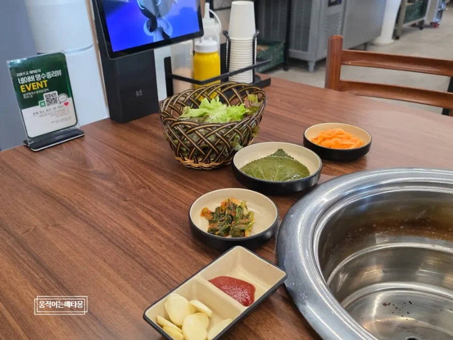 Spread of side dishes including lettuce, pickled perilla leaves, and yeolmu kimchi
