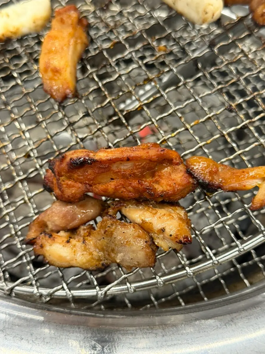 Golden-brown charcoal dakgalbi with rice cake skewers