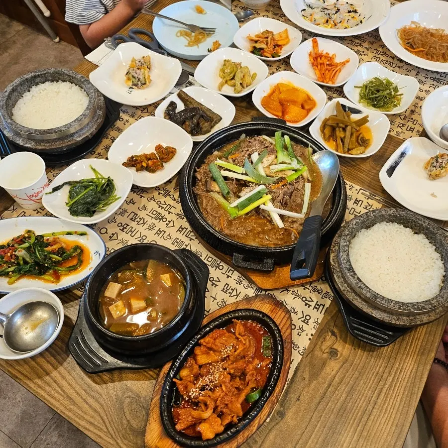 Table spread with seasonal namul side dishes and doenjang stew