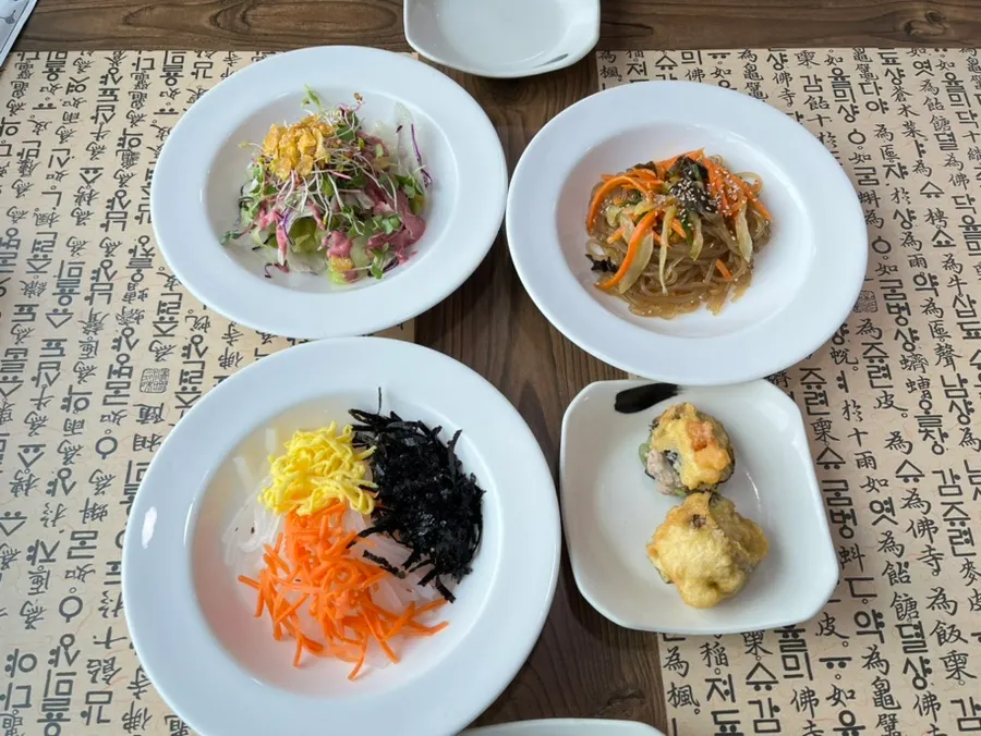 Pre-meal spread of salad, mung bean jelly, and japchae
