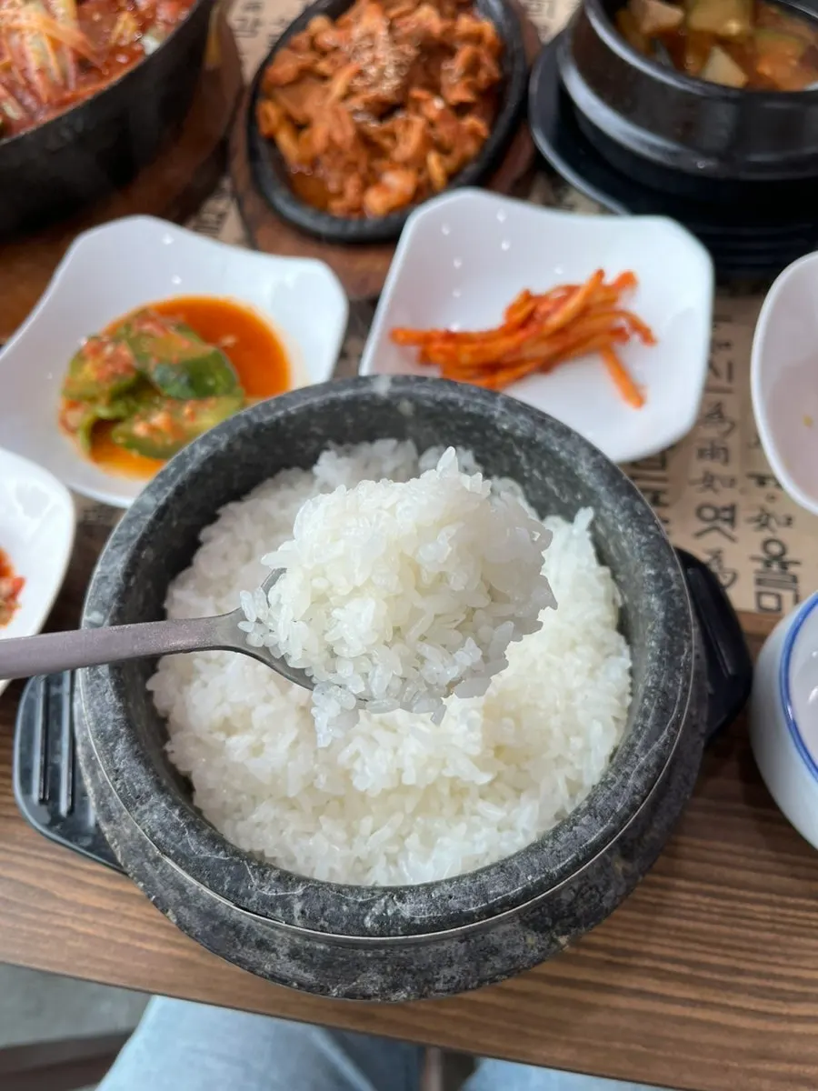 Sticky new-crop rice scooped from the stone pot