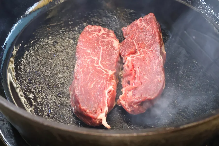 Hanwoo tenderloin placed on a heated cast iron pan