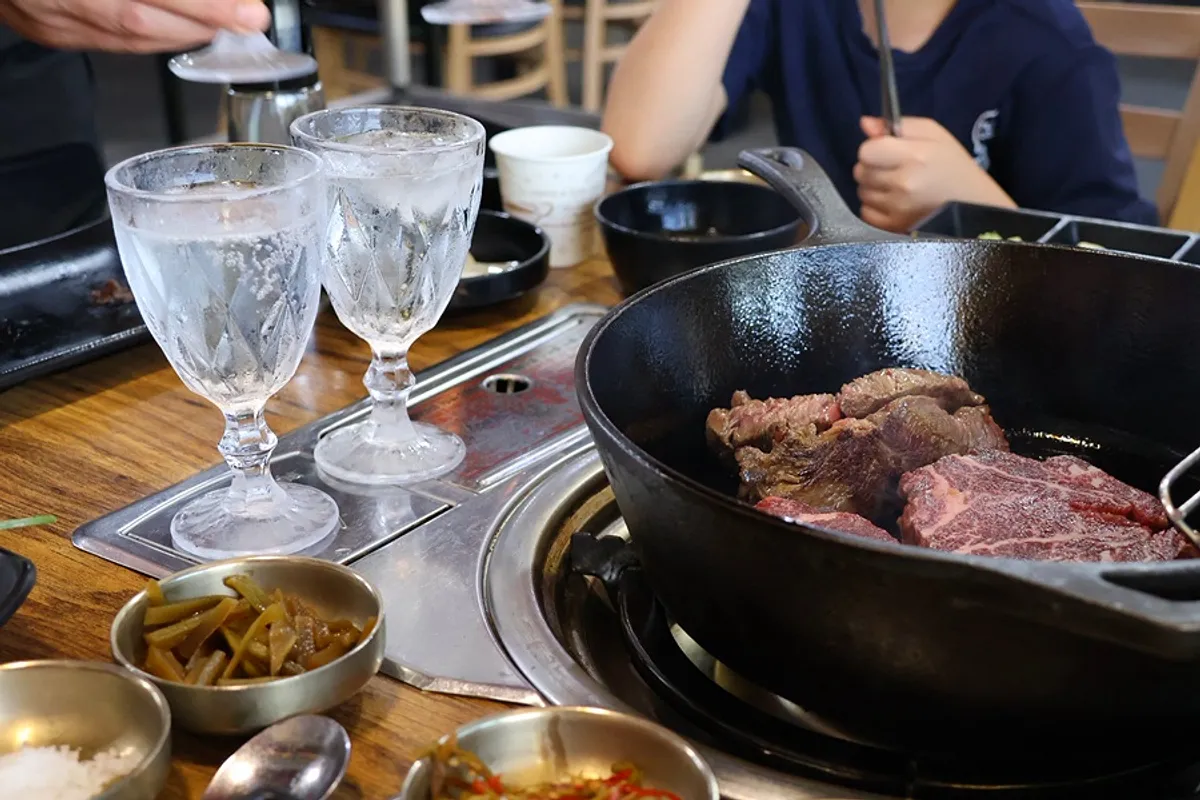 A glass of white wine paired with hanwoo tenderloin