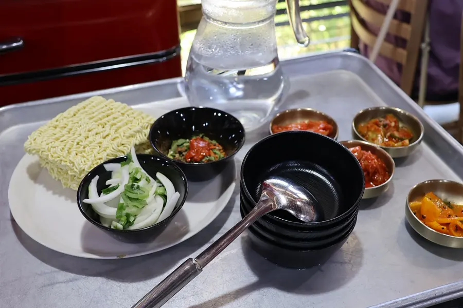 Hangover ramyeon starting to cook in the iron pan