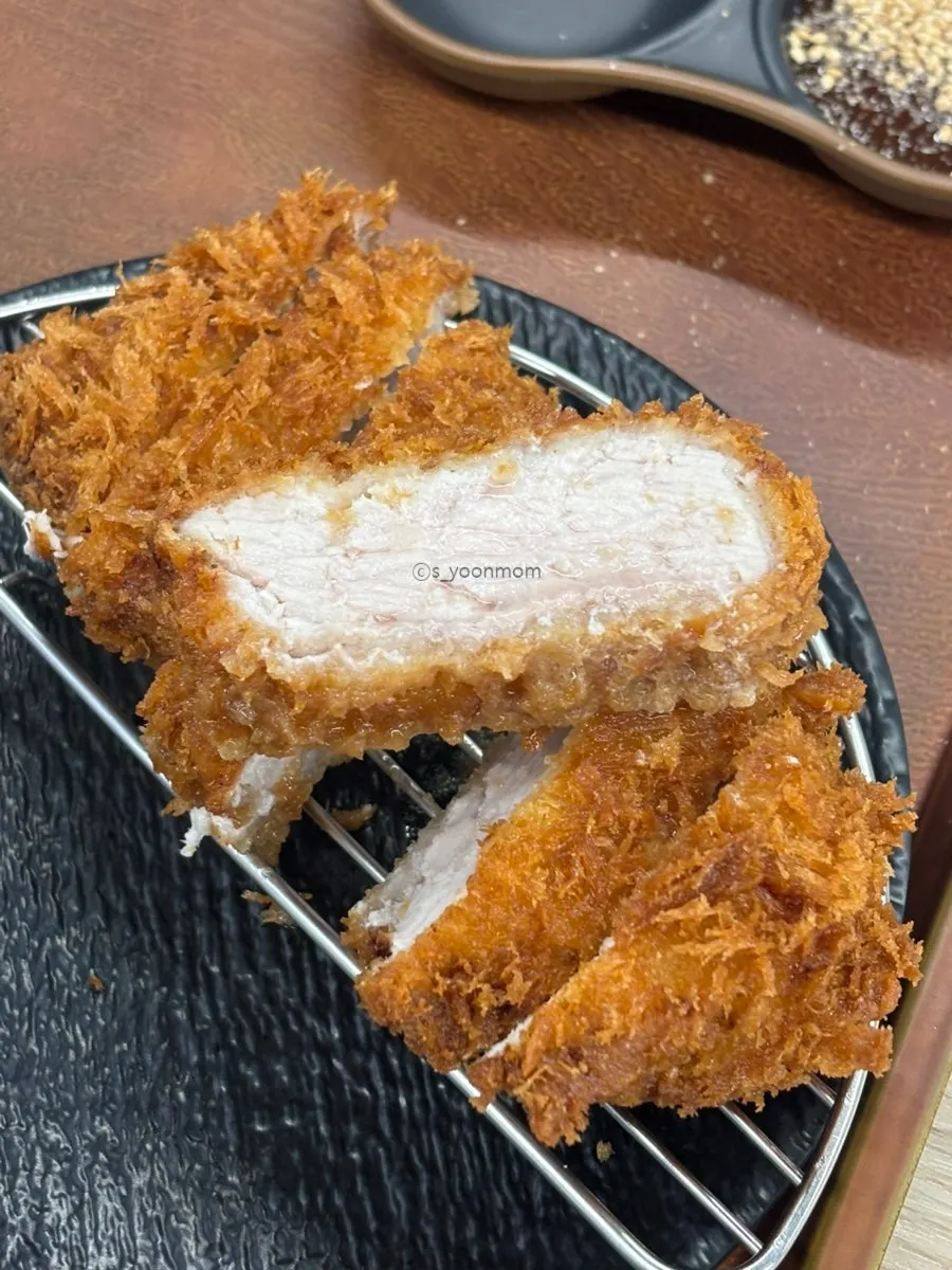 Tonkatsu sauce and sesame grinder on the table