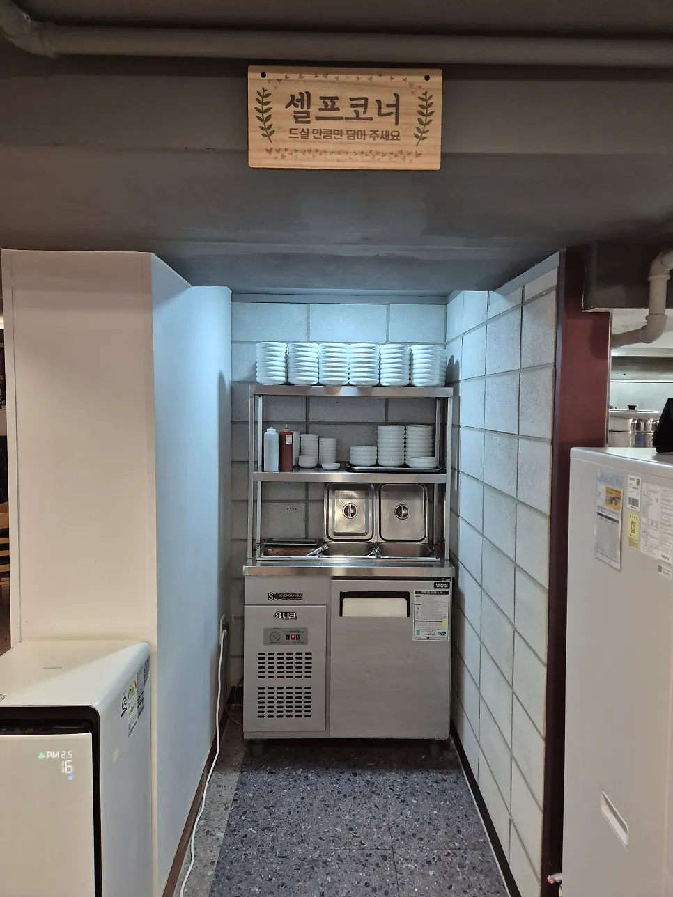 밑반찬과 소스가 놓인 셀프코너