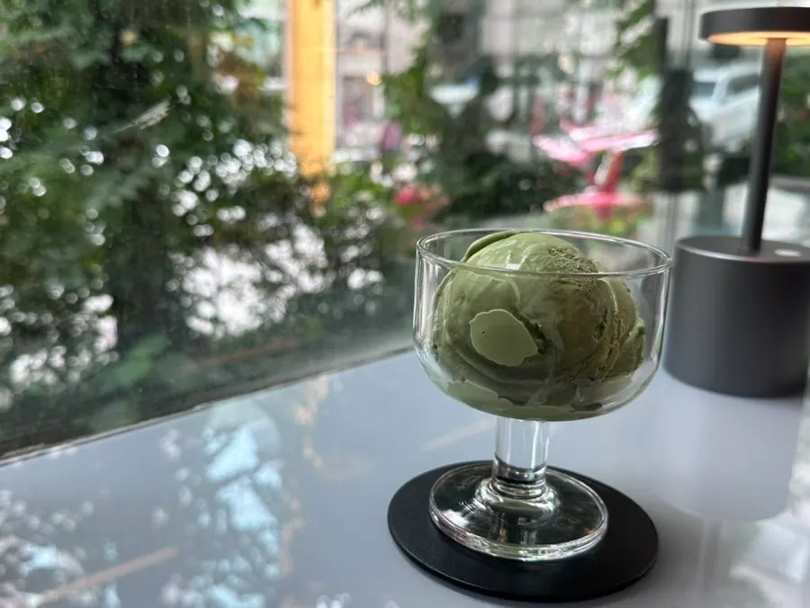 Dessert and book set against a rainy window view