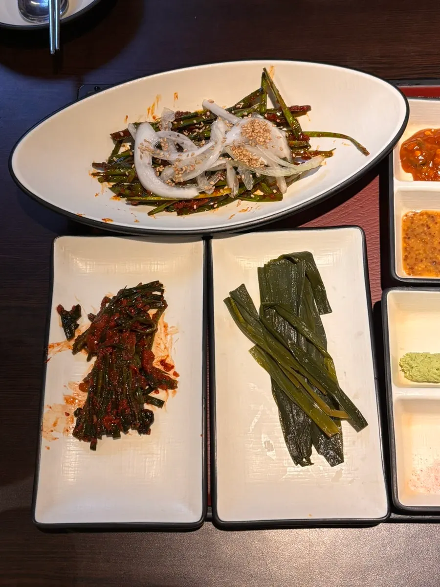 Basic side dishes including aster greens, chives, and scallion kimchi