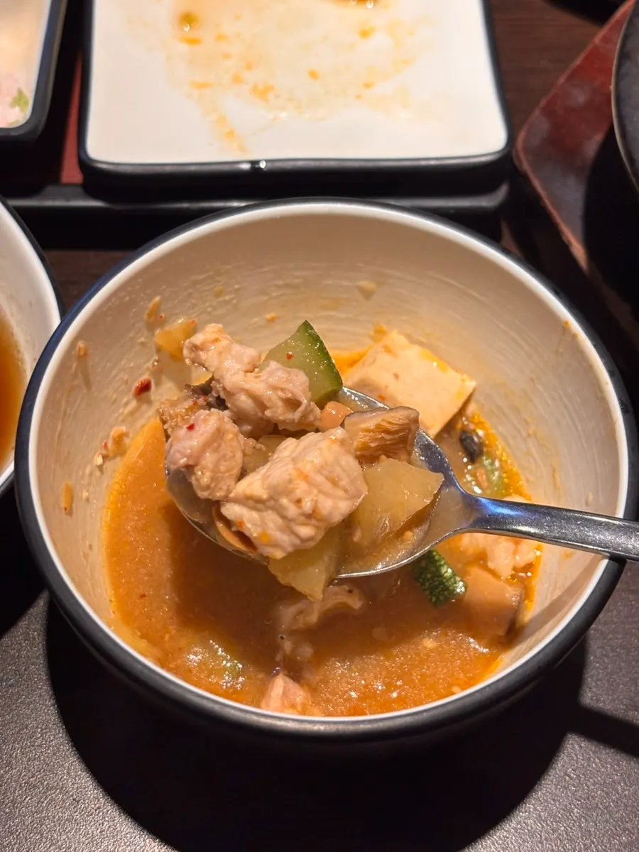 A spoonful of the pork intestine doenjang stew