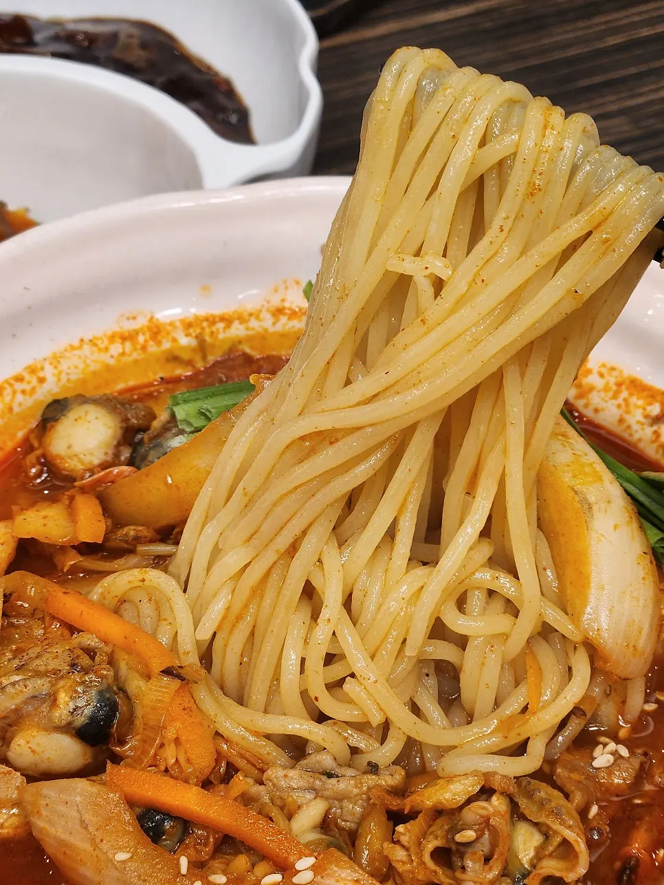 Jjamppong topped with chives and quail eggs