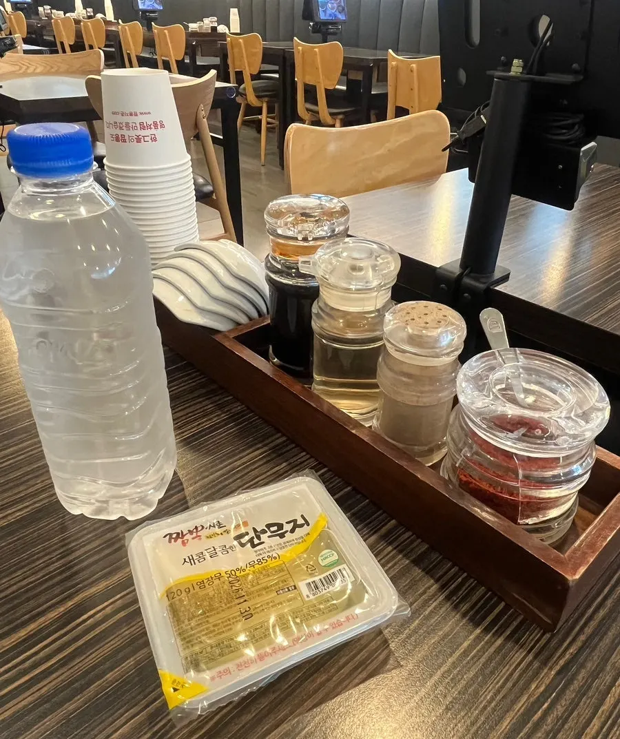 Basic table setting with bottled water and pickled radish