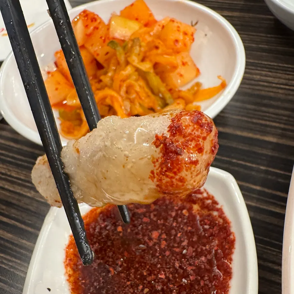 Sweet and sour pork dipped in soy sauce sprinkled with chili powder