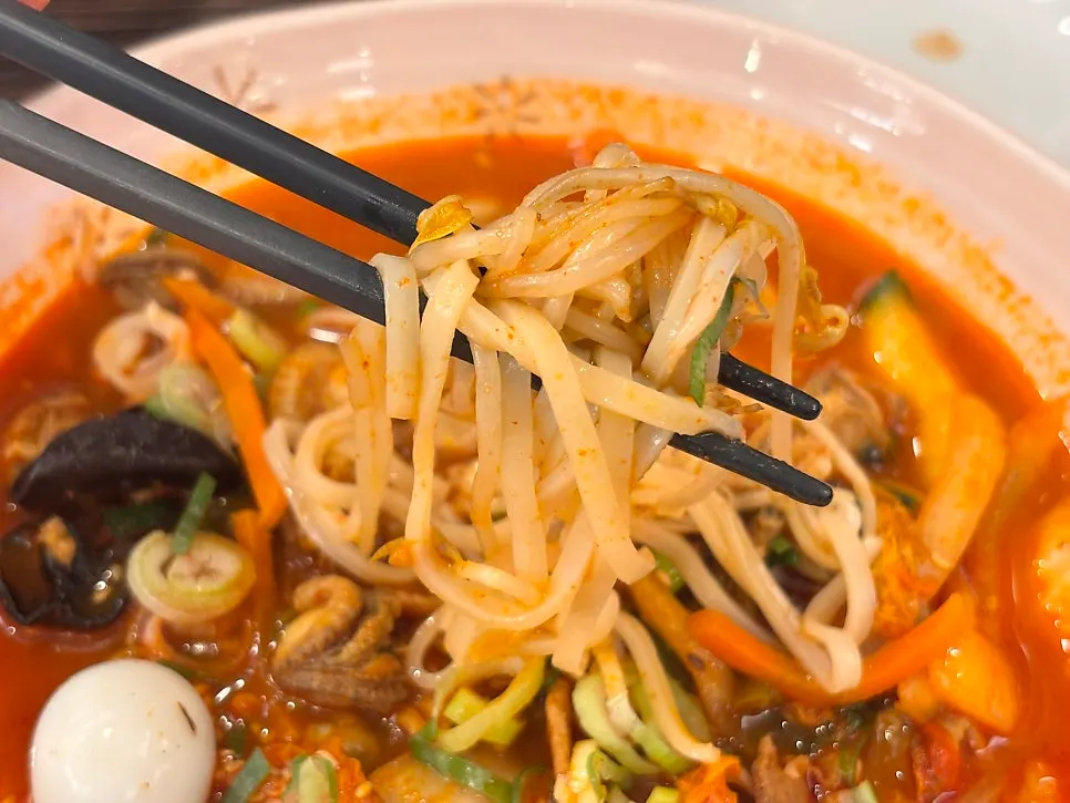 Rice noodles lifted up with chopsticks
