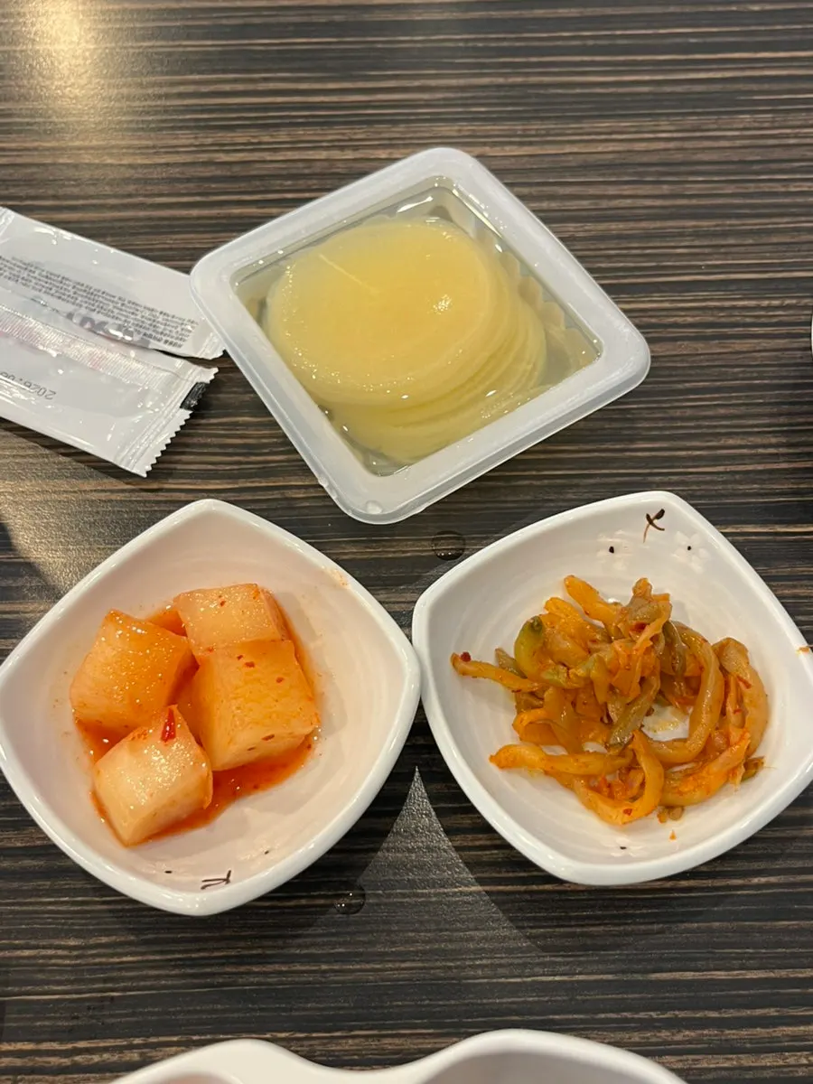 Self-serve corner with kimchi, jjasai, and onions