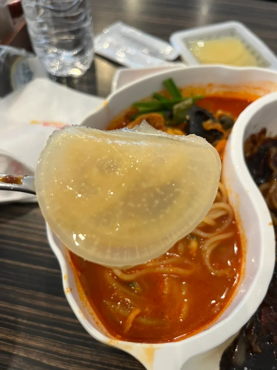 Jjajangmyeon noodles lifted with chopsticks