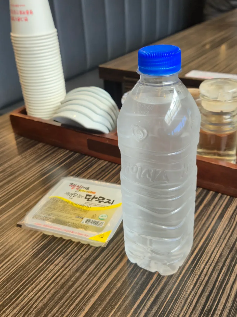 Individually packed pickled radish and bottled water side dishes