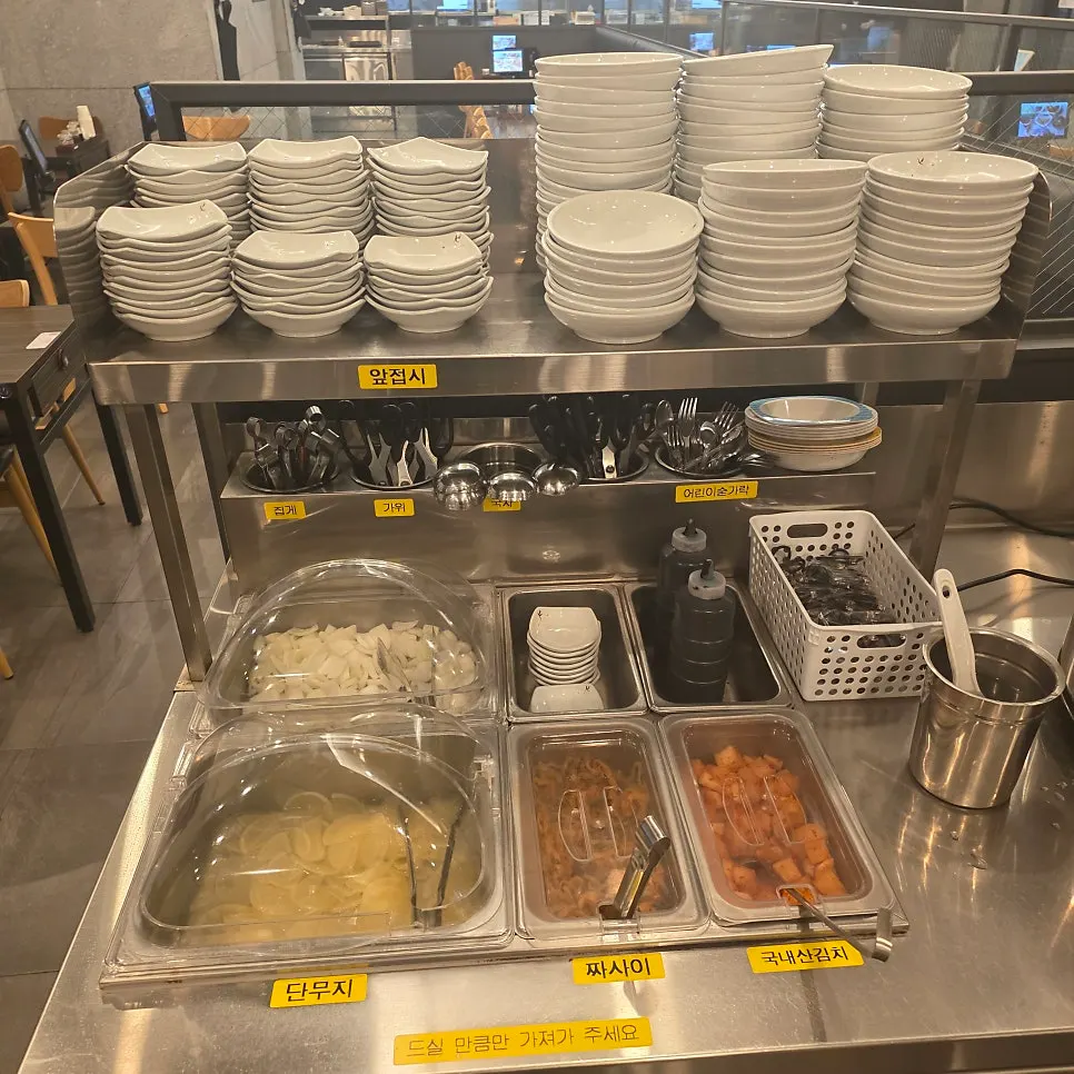 Self-serve bar with kimchi, rice, and pickled radish