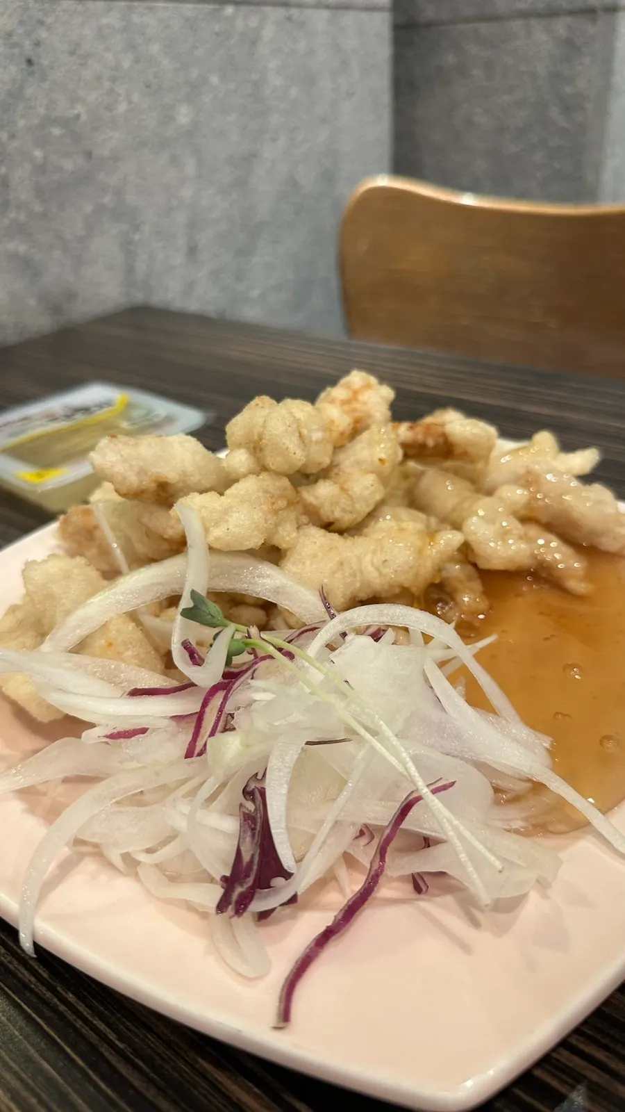 Glutinous sweet and sour pork served with sauce poured on top