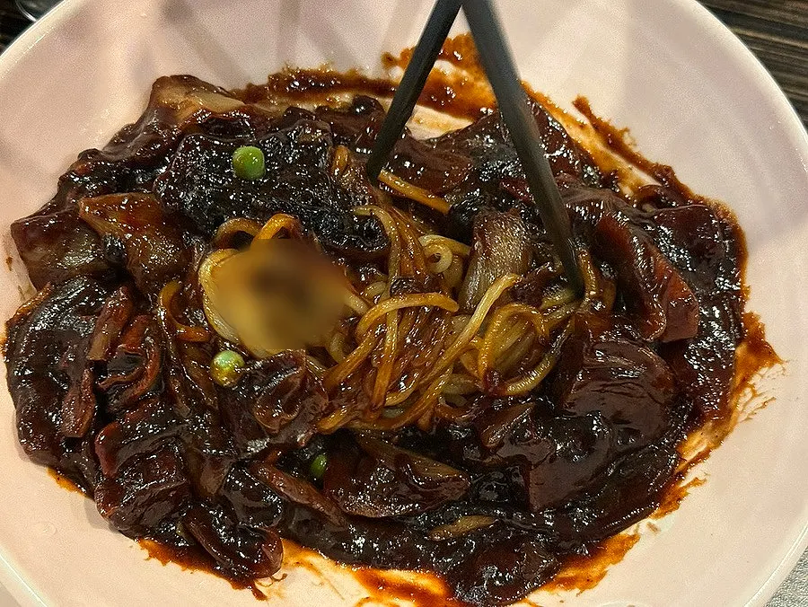 Noodles mixed with glossy jjajang sauce