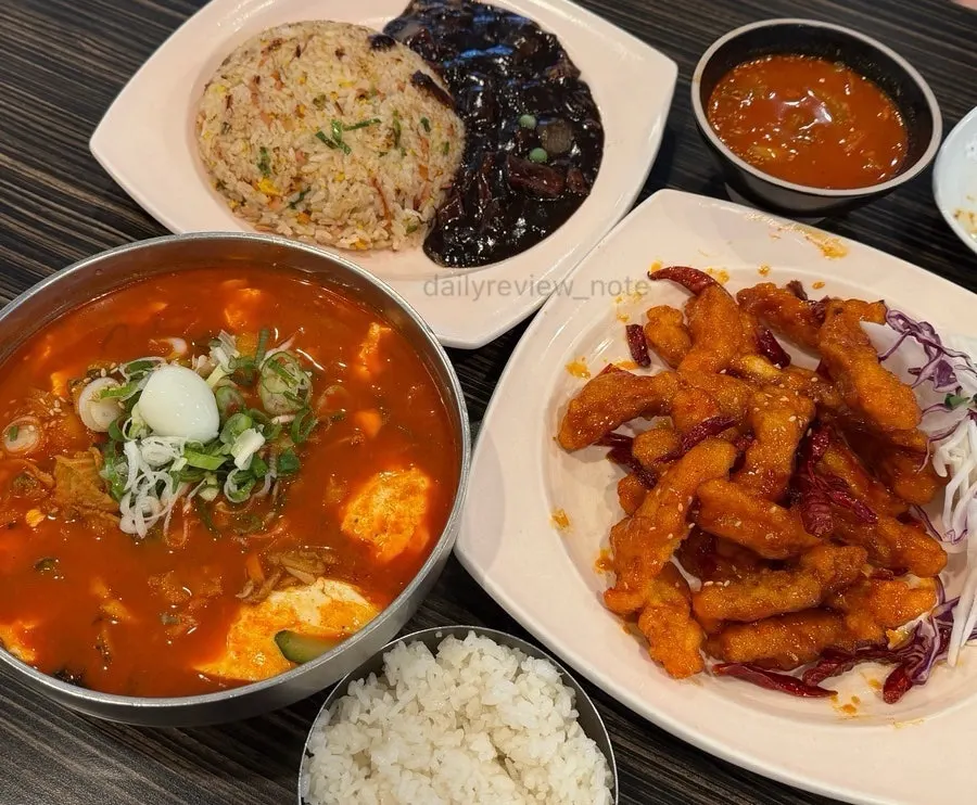 Jjamppong rice, fried rice, and sweet and sour pork set on the table
