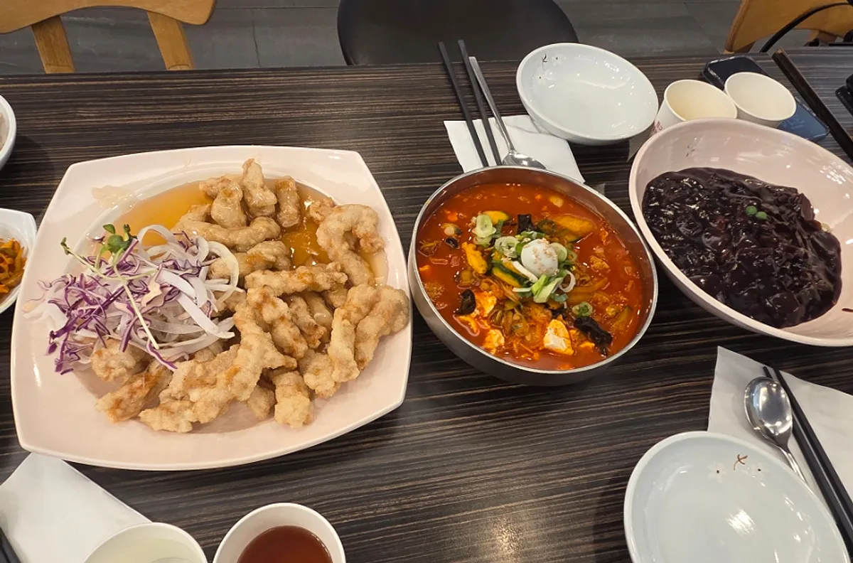Table set with the ordered sweet-and-sour pork and noodle dishes