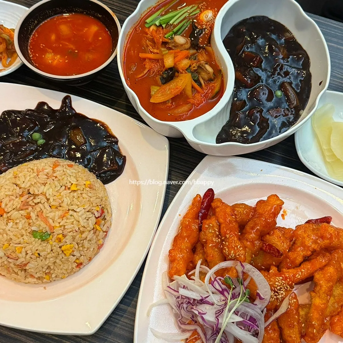 Table setup of sweet and sour pork, jjamjjamyeon, and fried rice shared by three