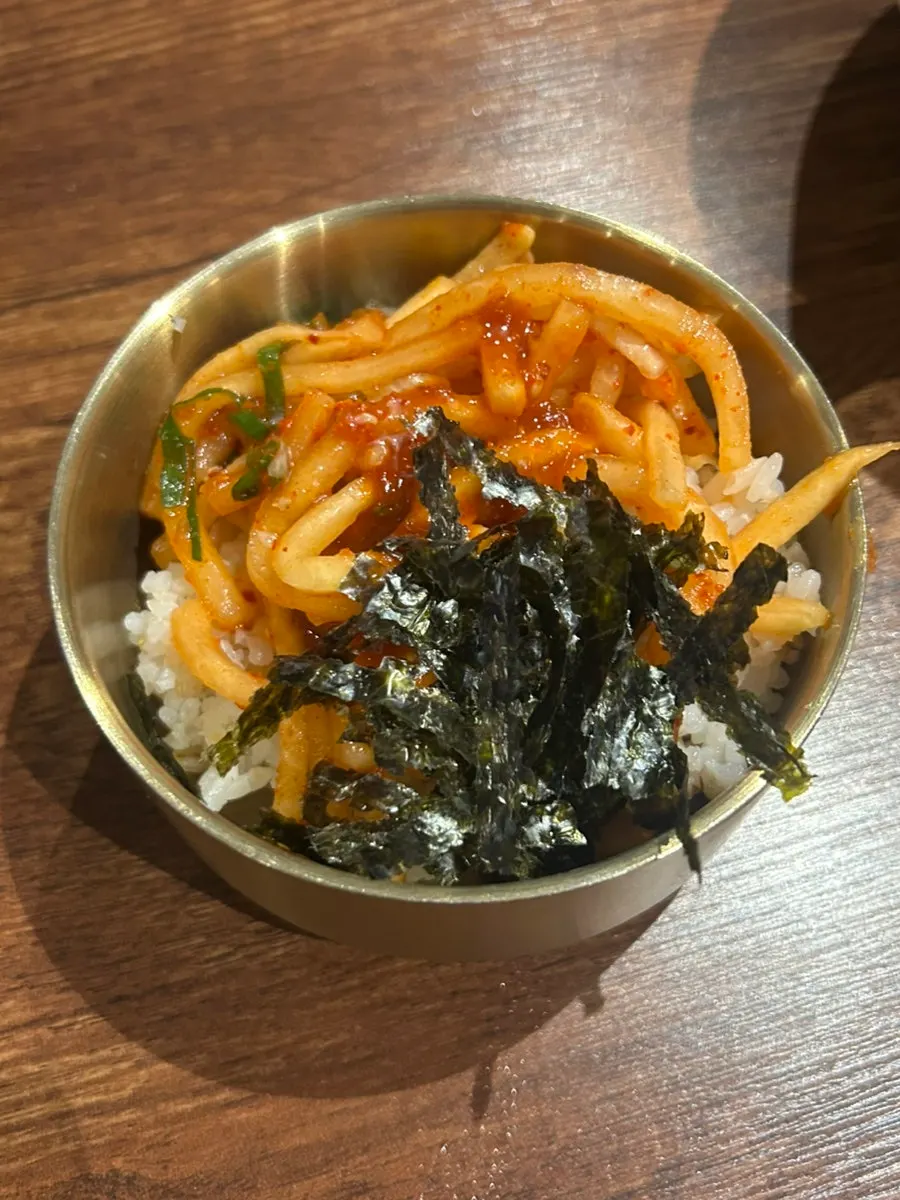 Bowl of barley rice topped with radish salad
