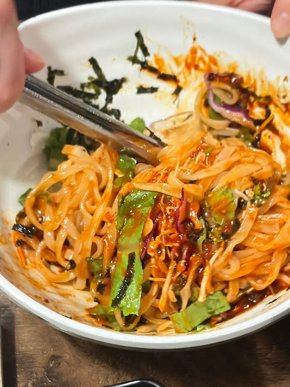 Bibim kalguksu topped with vegetables and shredded seaweed