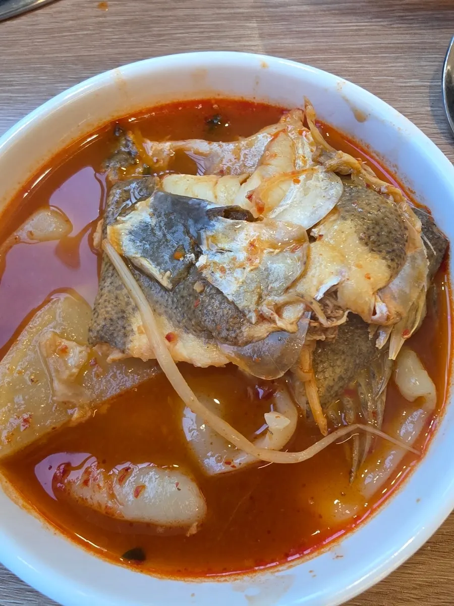 Dumpling noodles added to the spicy fish bone stew