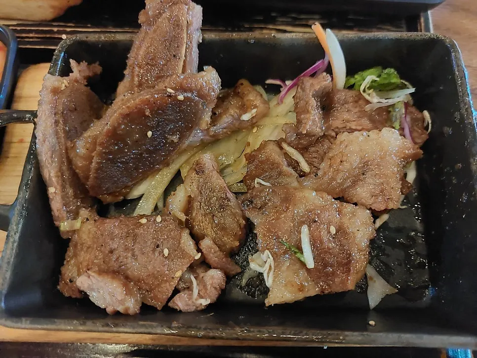 A piece of LA galbi with meat pulling off the bone