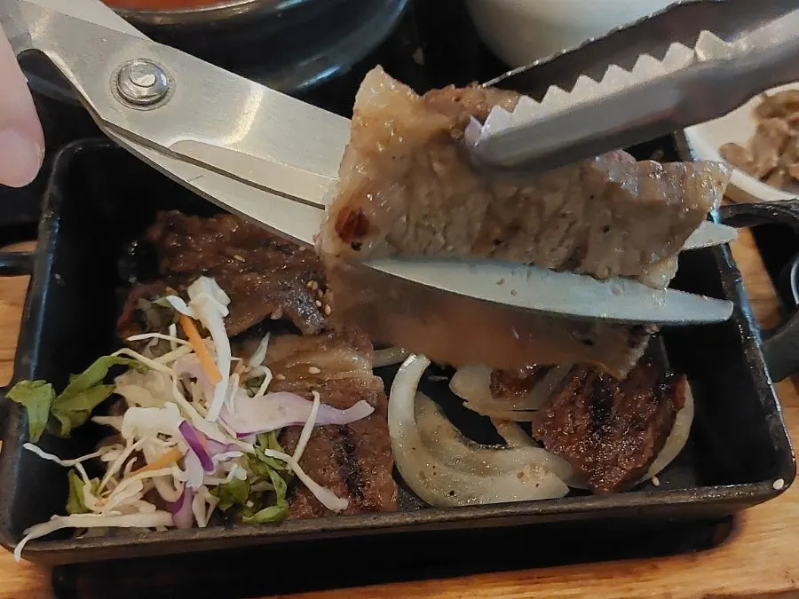 Soup and side dishes served alongside the galbi