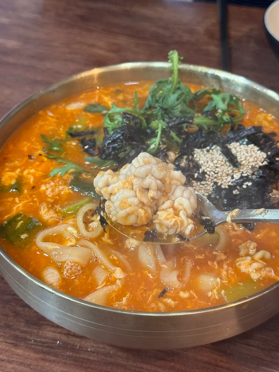 Chewy noodles lifted out of the jang kalguksu