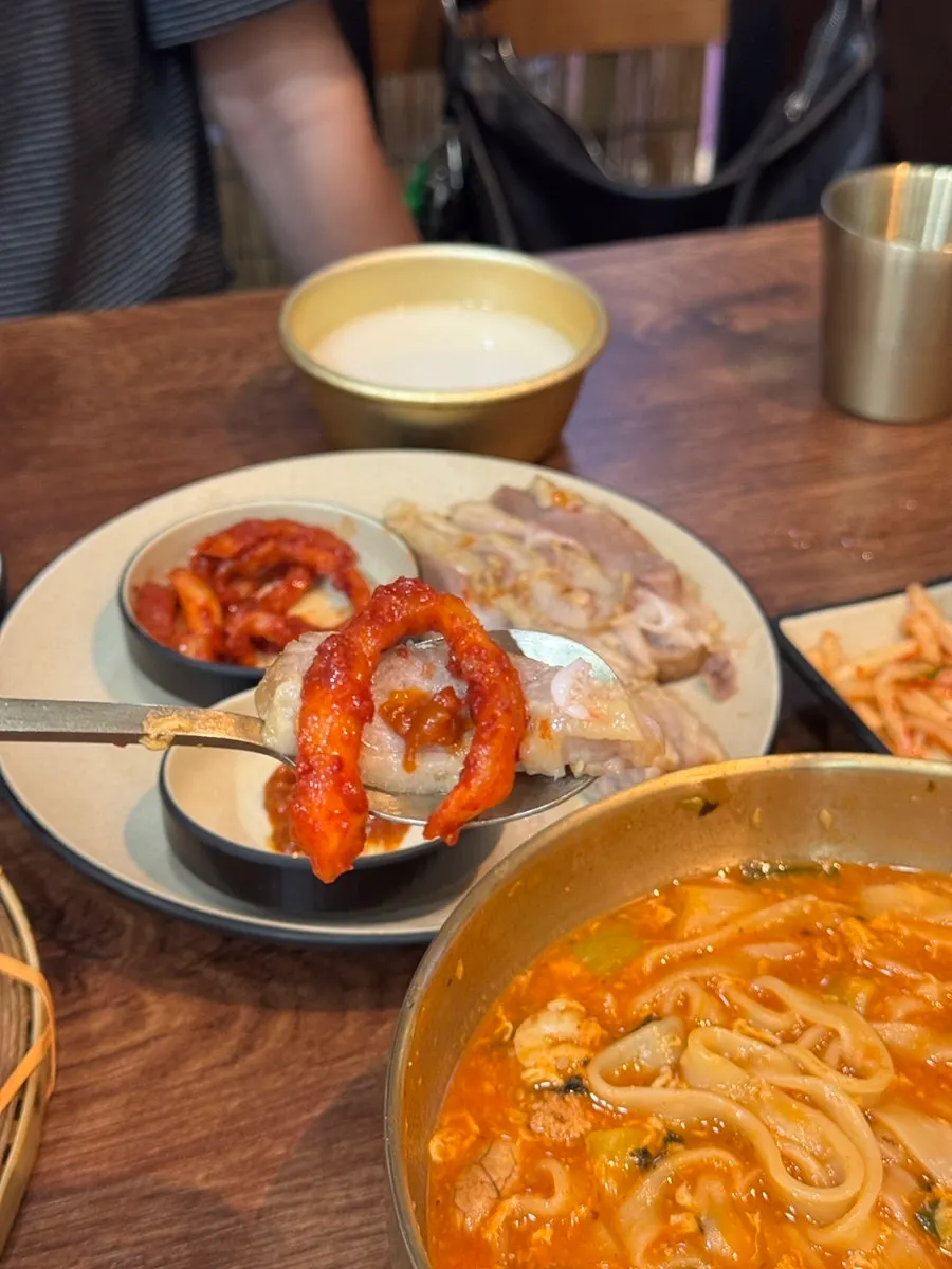 A piece of gabrisal bossam topped with kimchi