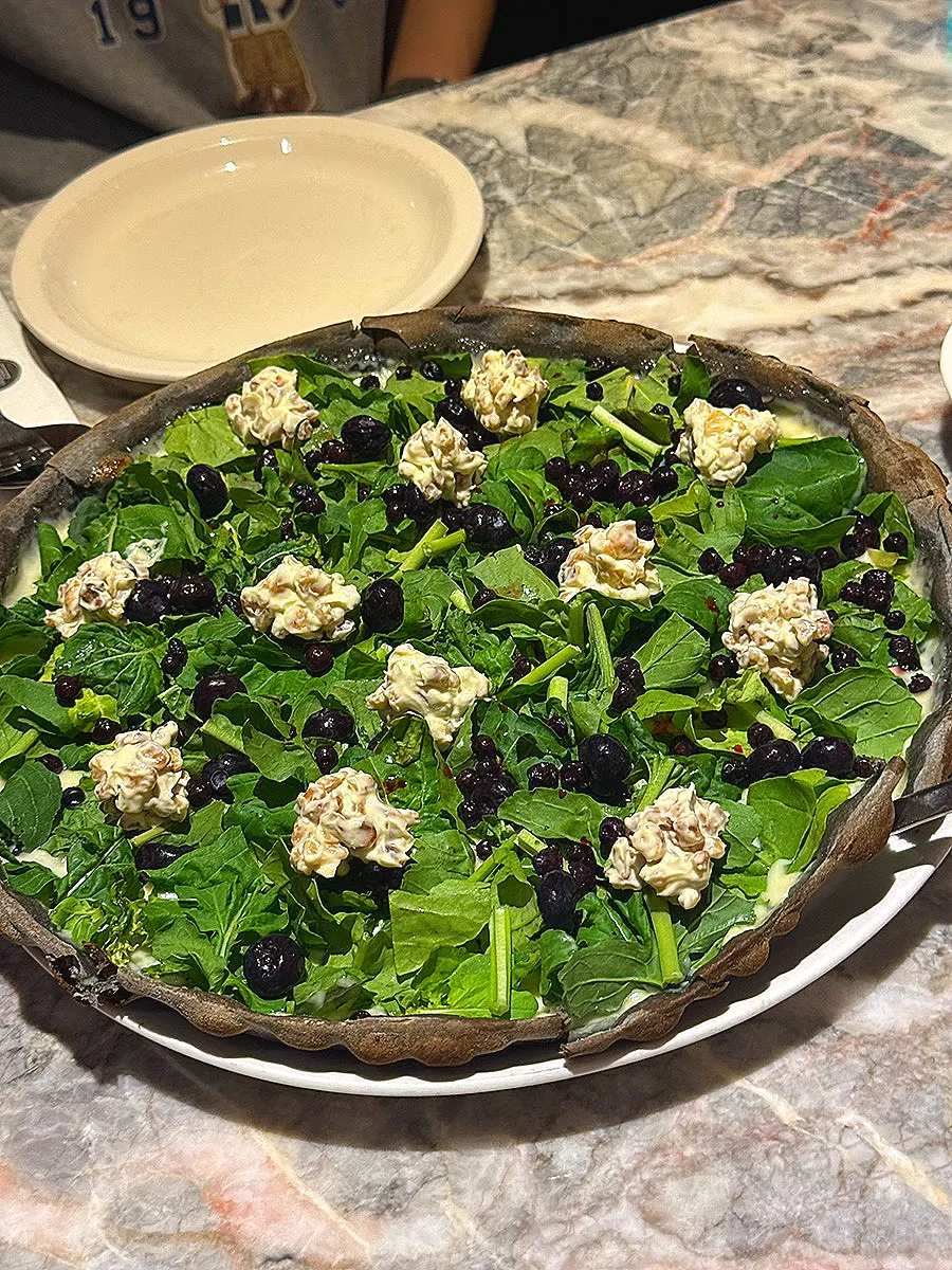 Blueberry arugula pizza