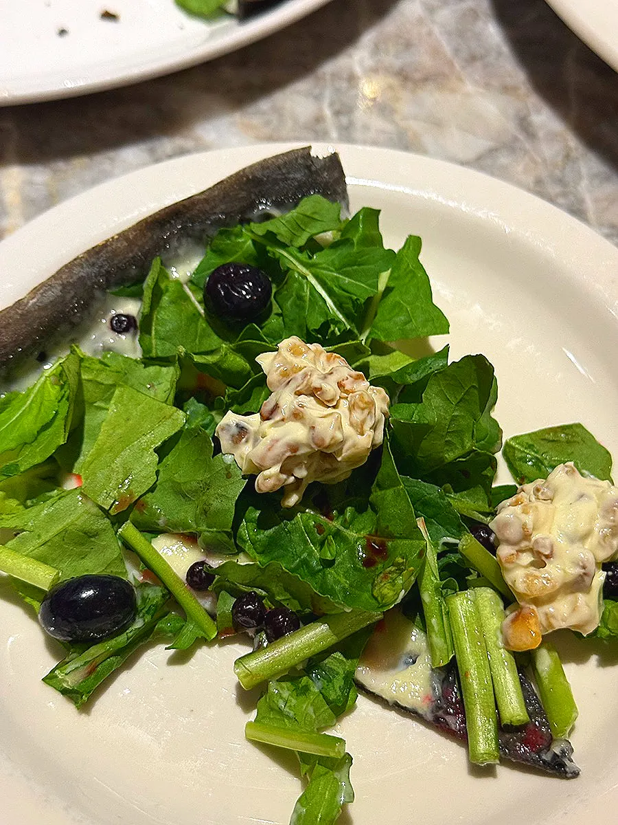 Squid-ink dough arugula pizza