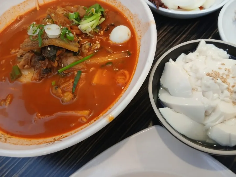 Table spread with rice-noodle jjamppong and fried dishes