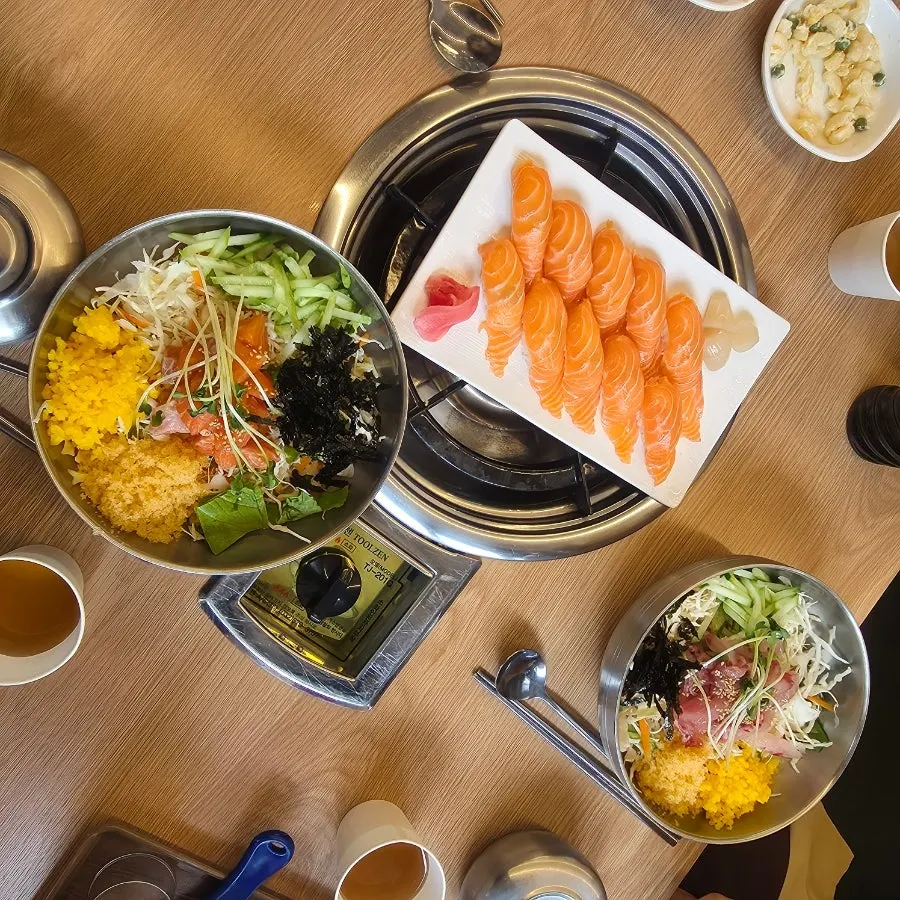A plate of salmon sushi served at the table