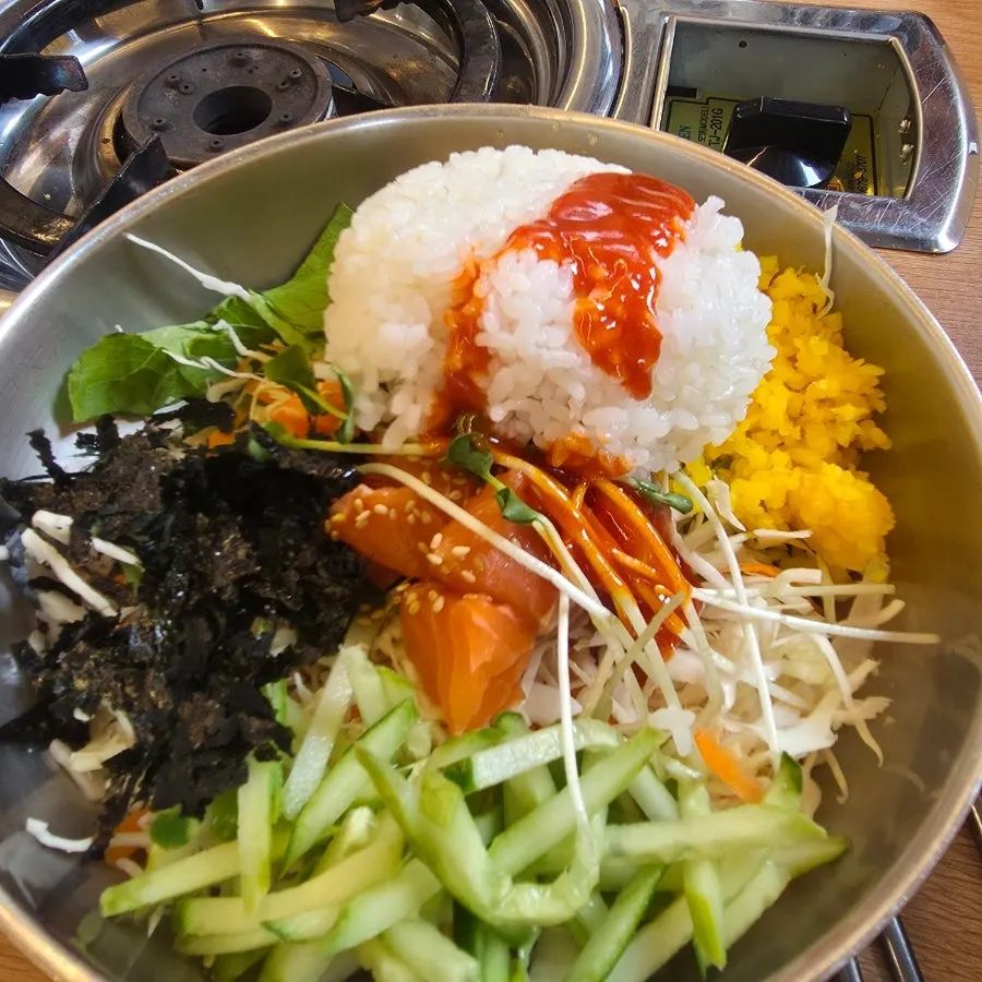 A bowl of raw fish rice mixed by hand