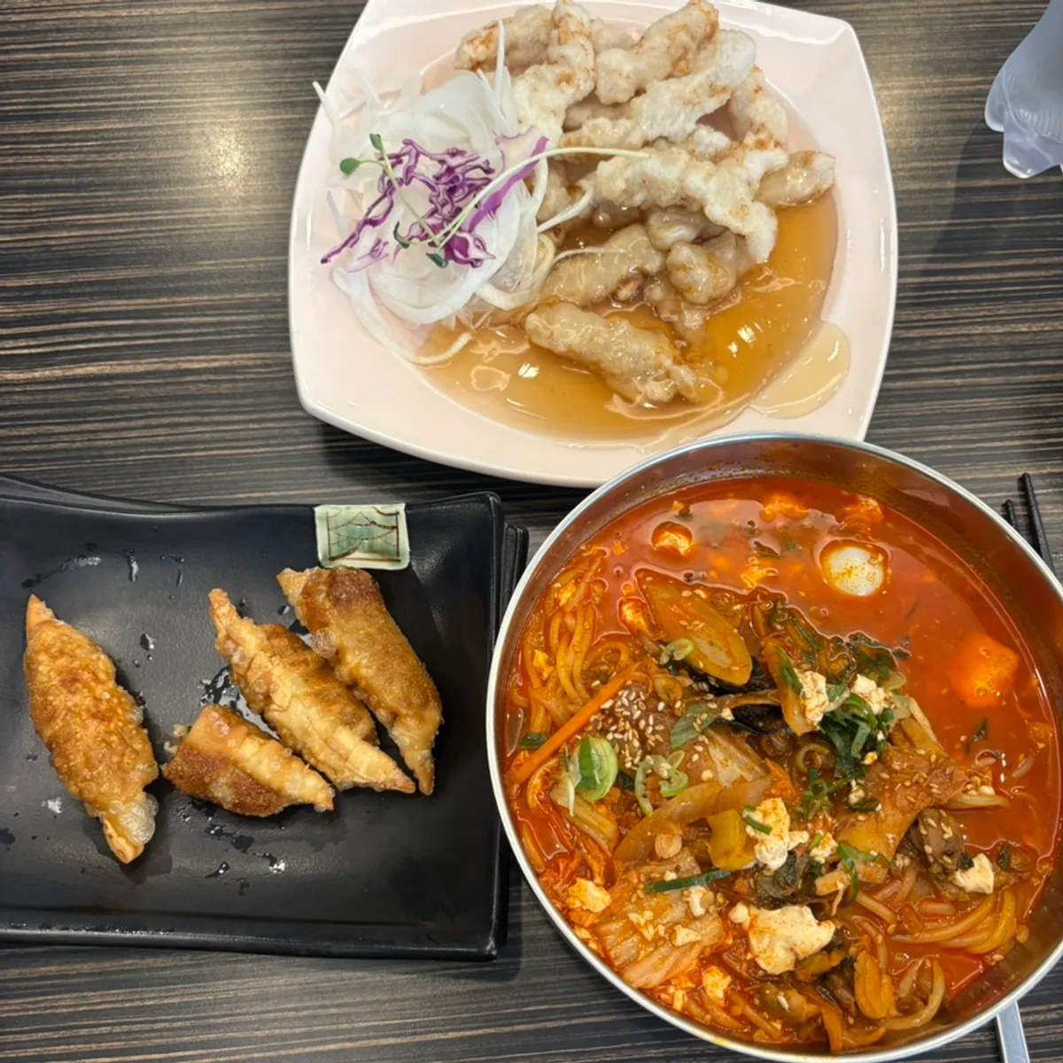 Table set with sweet and sour pork and soft tofu noodle soup