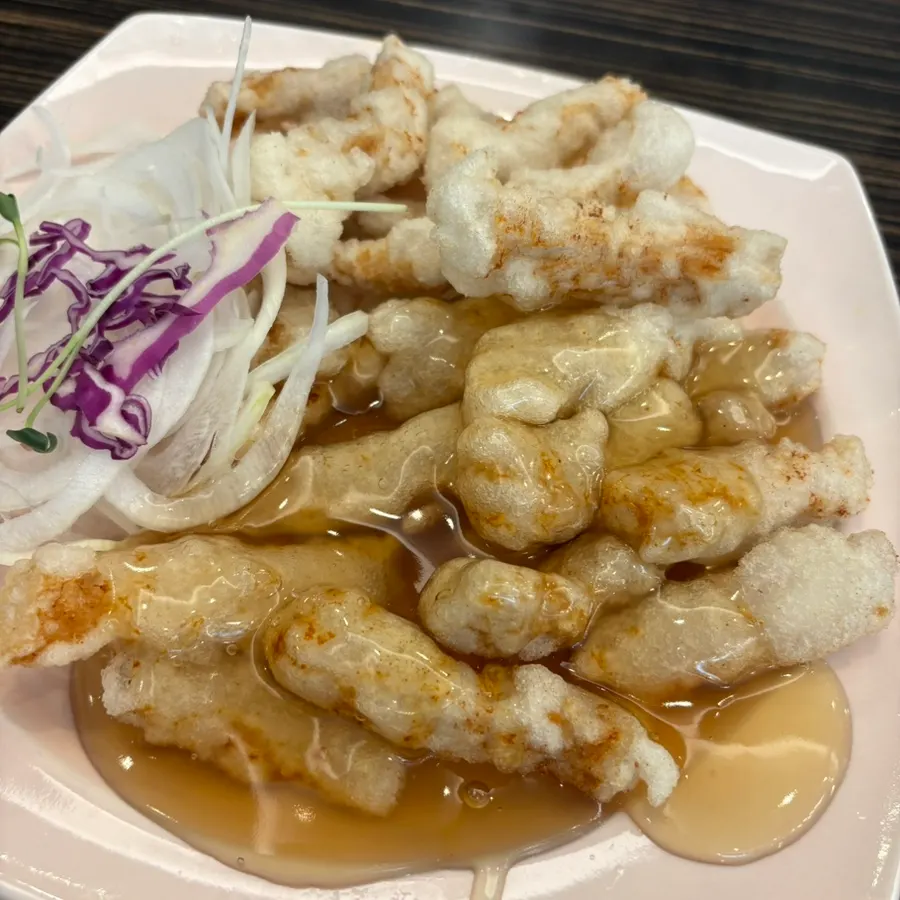 Sweet and sour pork with sauce poured over only half