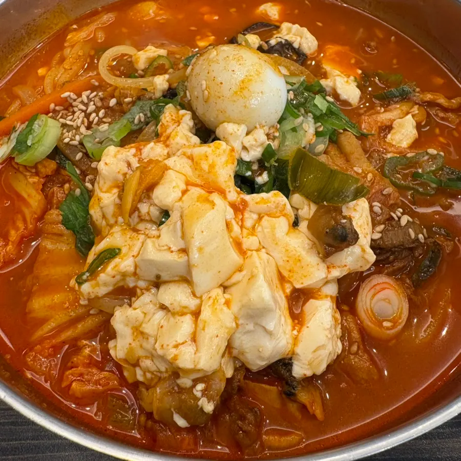 Close-up of the soft tofu noodle soup showing the ingredients